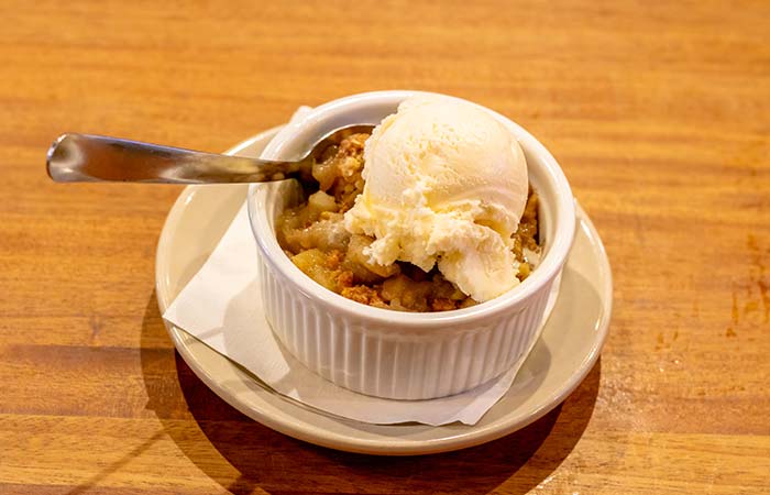 Warm apple crisp topped with ice cream created by Wurst Bier Hall in West Fargo ND.