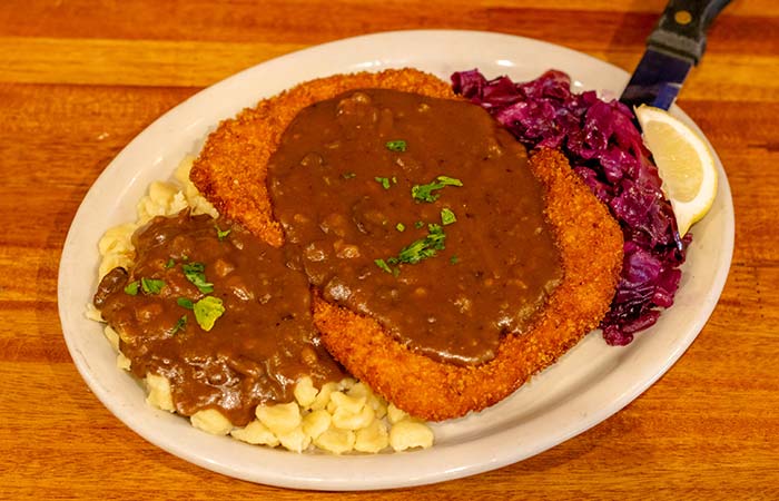 Breaded boneless pork chop with gravy served by Wurst Bier Hall in West Fargo ND.