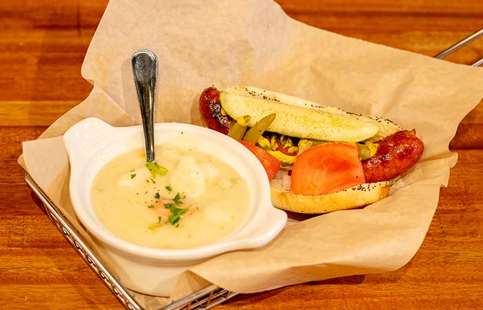 Sausage loaded with condiments and tomatoes and served with soup at Wurst Bier Hall in West Fargo ND.