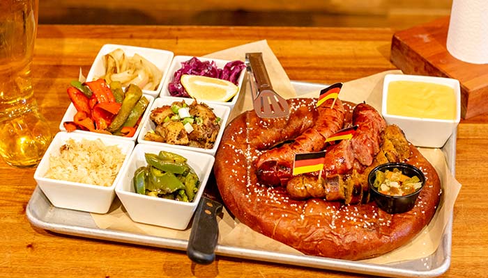 Giant Bavarian pretzel served with sausages and various toppings at Wurst Bier Hall in West Fargo ND.
